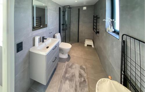 a bathroom with a white sink and a toilet at Awesome Home In Uddevalla With Wifi in Uddevalla