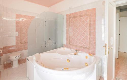 a white bath tub in a bathroom with a toilet at Awesome Apartment In Castel Rigone in Castel Rigone