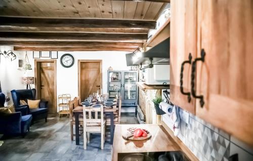 a kitchen and dining room with a table and chairs at Stunning Home In Kostanjevac in Kostanjevac