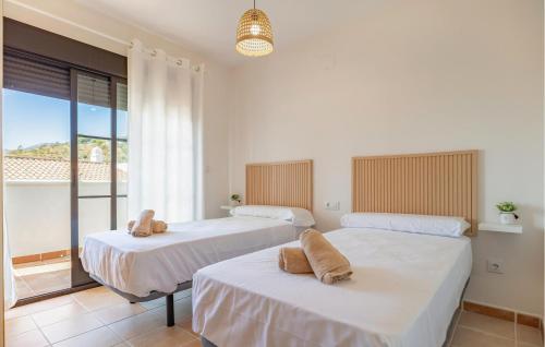 two beds in a room with a balcony at Gorgeous Apartment In Itrabo With Wifi in Ítrabo