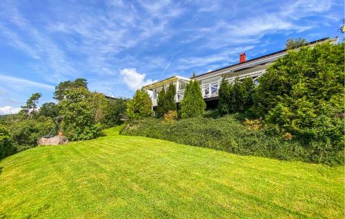 a house on a hill with a green lawn at Beautiful Home In Uddevalla With Wifi in Uddevalla