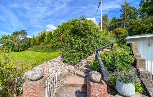 a set of stone stairs with a fence and plants at Beautiful Home In Uddevalla With Wifi in Uddevalla