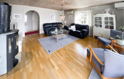 a living room with black furniture and a fireplace at Beautiful Home In Uddevalla With Wifi in Uddevalla
