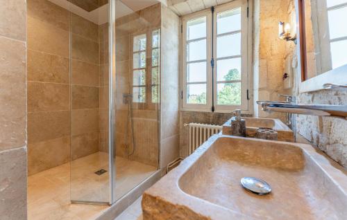 a bathroom with two sinks and a shower at Le Clos Montaugé in Virsac