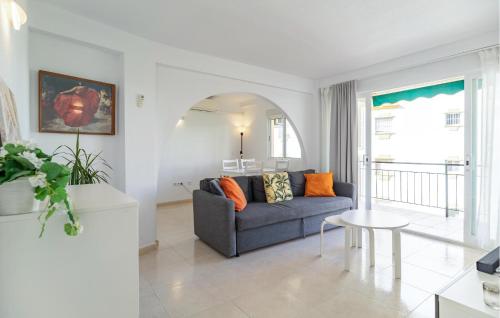 a living room with a couch and a table at Nice Apartment In Fuengirola With Wifi in Fuengirola