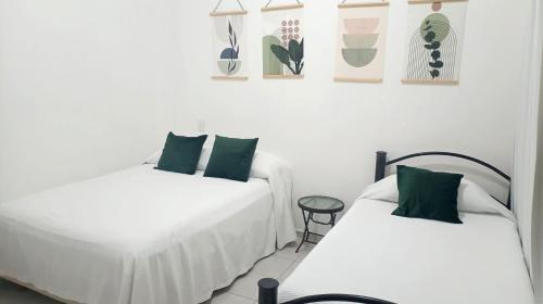 two beds sitting next to each other in a room at Tauch Cancún Centro in Cancún