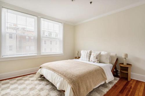 a white bedroom with a bed and a window at Dreamy 2BR in Downtown Princeton in Princeton