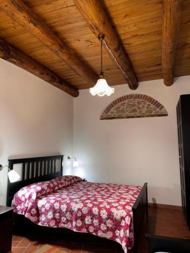 a bedroom with a bed and a wooden ceiling at B&B Antico Casale in Fuscaldo