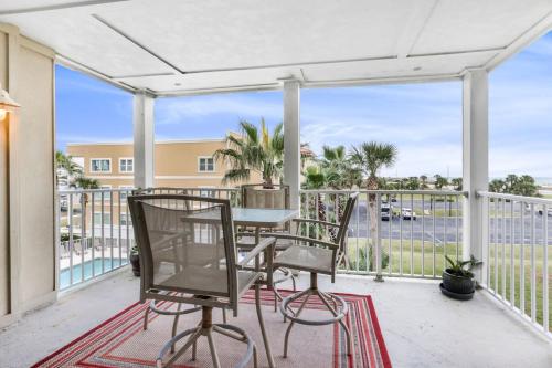 a patio with a table and chairs on a balcony at Portside 204- Best of Beach & Bay in Orange Beach