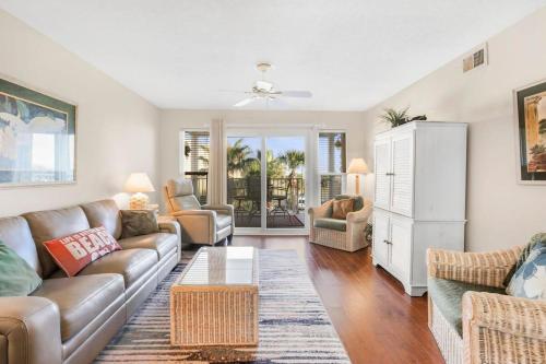 a living room with a couch and a table at Portside 204- Best of Beach & Bay in Orange Beach