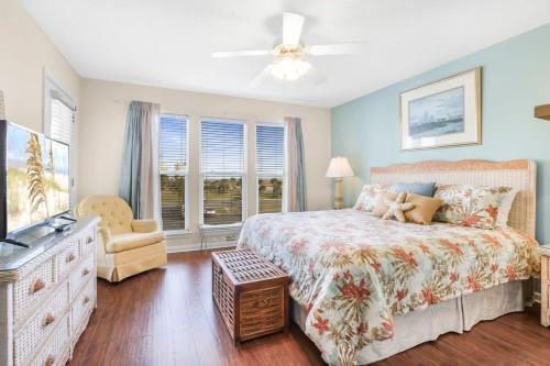 a bedroom with a bed and a dresser and a window at Portside 204- Best of Beach & Bay in Orange Beach