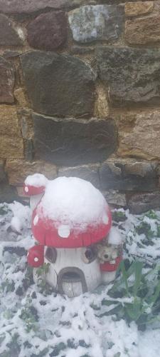a fire hydrant covered in snow next to a wall at Το Κονάτζι in Statos and Ayios Photios