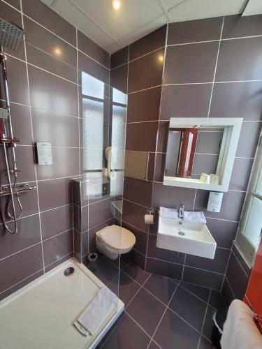 a bathroom with a toilet and a sink and a tub at KYRIAD ORANGE Centre Ville - HOTEL & RESTAURANT & BAR - La Galerie d'Art des Princes - Provence Alpes Côte d'Azur - France - Proche A7-A9 - exit21- Châteauneuf-du-Pape Avignon Bollene Nimes - 24h-24h in Orange