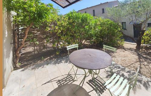 une table et des chaises sur un patio arboré dans l'établissement Beautiful Home In Saint Laurent De La Cabrerisse, à Saint-Laurent-de-la-Cabrerisse