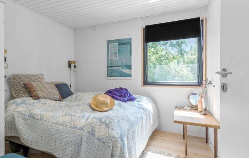 a bedroom with a bed with a hat on it at Beautiful Home In Højby With Wifi in Højby