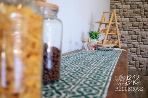 a table with a glass bottle on top of a table at Bellerose Guesthouse in Klerksdorp