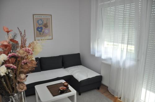 a living room with a couch and a table at Apartman H in Sesvete