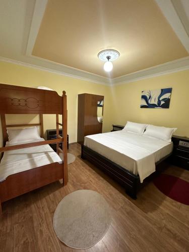 a bedroom with two beds and a rug at Xhani Camping&Farm in Gucia e Re