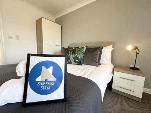 a room with a bed with a sign on it at No 203 by Blue Skies Stays in Stockton-on-Tees