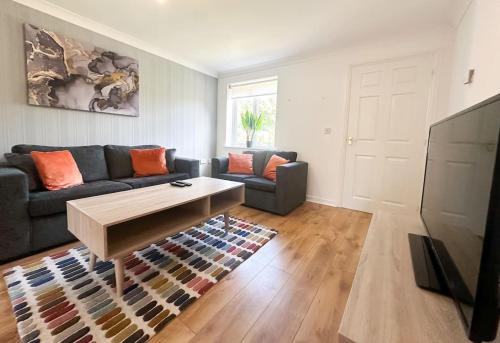 a living room with a couch and a coffee table at No 203 by Blue Skies Stays in Stockton-on-Tees