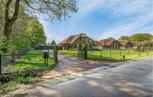 a house with a fence on the side of a road at 3 Bedroom Cozy Home In Voorthuizen in Voorthuizen