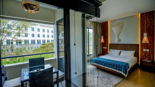 a bedroom with a bed and a large window at Warwick Centre in Nairobi