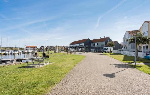a walkway next to a marina with houses and boats at Lovely Apartment In Rudkøbing in Rudkøbing