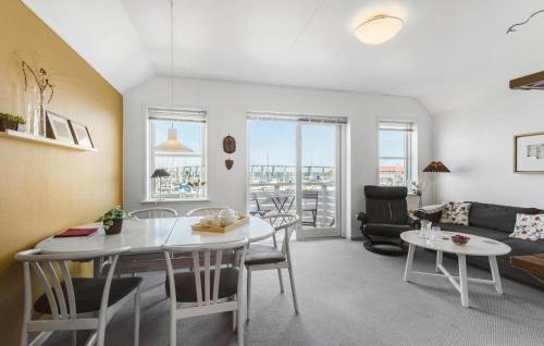 a living room with a table and a couch at Lovely Apartment In Rudkøbing in Rudkøbing
