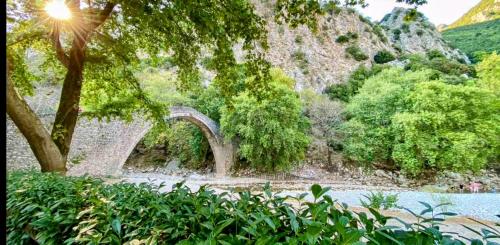 a bridge over a body of water with trees at Villa Pialia in Piáleia