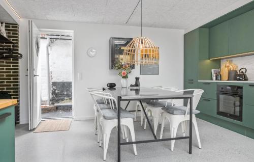 a dining room with a table and chairs at 3 Bedroom Stunning Home In Nordborg in Nordborg