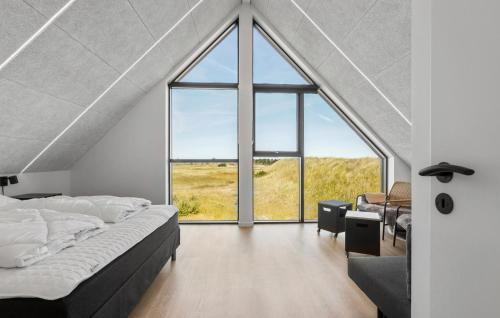 a bedroom with a large window and a bed at 3 Bedroom Nice Home In Skagen in Skagen