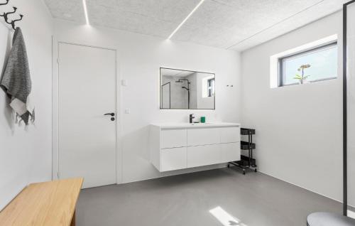 a white bathroom with a sink and a mirror at 3 Bedroom Nice Home In Skagen in Skagen
