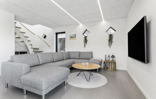 a living room with a couch and a table at 3 Bedroom Nice Home In Skagen in Skagen