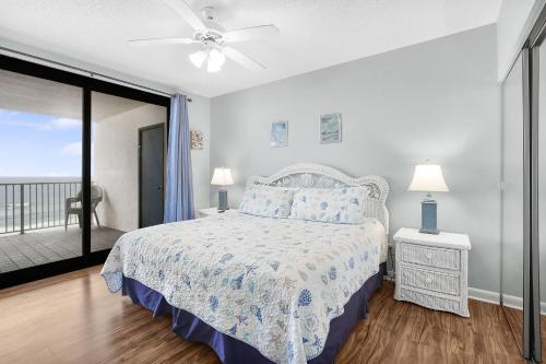 a white bedroom with a bed and a balcony at Windward Pointe 801- East corner-unit beachfront in Orange Beach