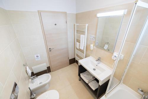 a bathroom with a sink and a toilet and a mirror at Armonia by Aristocratis in Tîrgu Neamţ