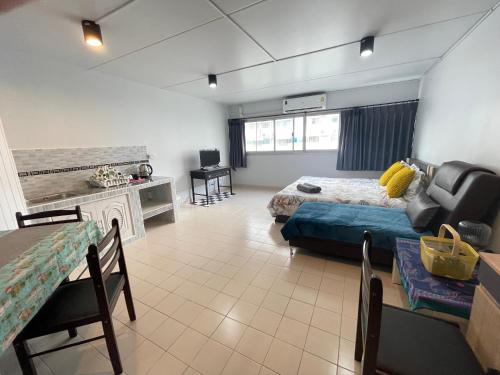 a large room with a bed and a table and chairs at Lively Impact C3-C9 in Nonthaburi