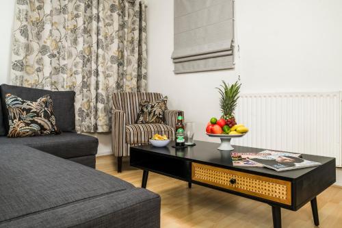 a living room with a coffee table with fruit on it at 2BR Modern Flat With Free Parking - Private Garden in Heeley