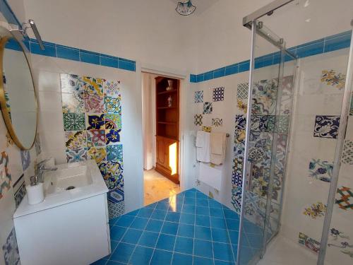 a bathroom with a sink and a shower at Palazzo Sardanelli in Pizzo