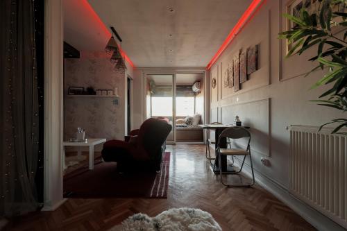 a living room with a red light on the ceiling at Eagle's Nest by Short-Stay in Baia Mare