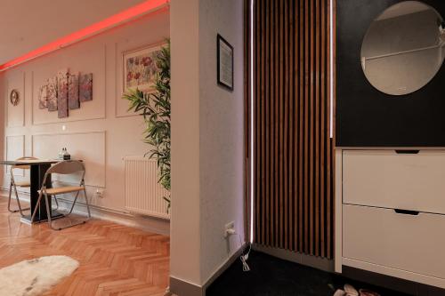 a room with a table and a mirror on a wall at Eagle's Nest by Short-Stay in Baia Mare