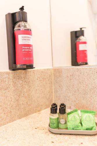a bottle of mouthwash sitting on a counter in a bathroom at Ramada by Wyndham Campinas Viracopos in Campinas