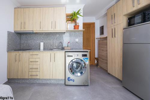 a kitchen with a washing machine in a kitchen at Arinaga Beach - Sea View & Terrace Apartment in Arinaga