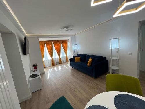 a living room with a couch and a table at MK Apartments in Piatra Neamţ