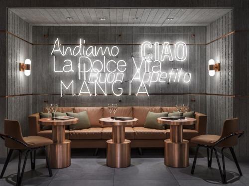 a restaurant with a bench and tables and a sign at The Venetian Resort Las Vegas By Suiteness in Las Vegas