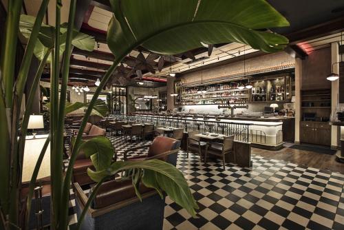 a restaurant with a large green plant in the foreground at The Venetian Resort Las Vegas By Suiteness in Las Vegas