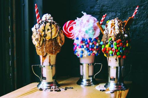 three ice cream cones with milkshakes on a table at The Venetian Resort Las Vegas By Suiteness in Las Vegas