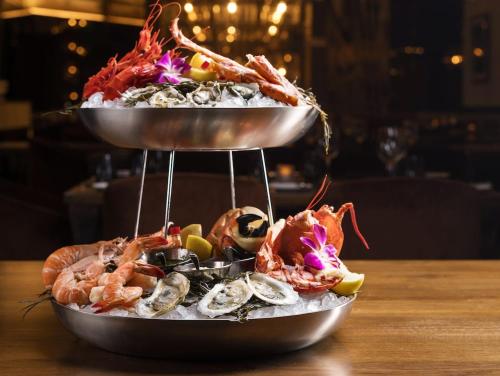 a seafood platter with shrimp and oysters on a table at The Venetian Resort Las Vegas By Suiteness in Las Vegas