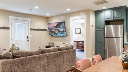 a living room with a couch and a refrigerator at Teton Crest Apartment in Driggs