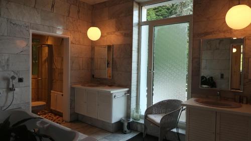 a bathroom with a tub and a sink and a mirror at Awesome Erichs Finest in Herten