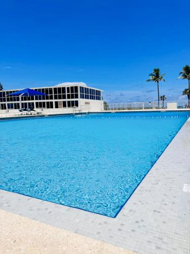 a large swimming pool in front of a building at Castle 1120 Bayview Studio, Beach access, Pool, Tennis, Free parking in Miami Beach